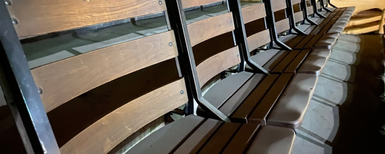 a row of old wooden seats at Cow Palace in San Francisco